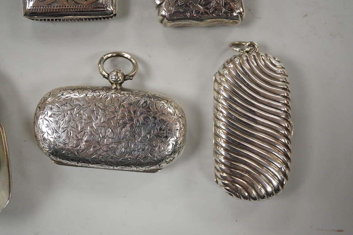 Two late Victorian silver twin compartment sovereign cases, Birmingham, 1891 & 1896, both approx. 57mm, a gold plated sovereign case, together with three silver vesta cases, a silver purse and a silver mounted notebook.